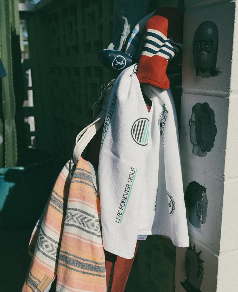 Multiple Golf Caddy Towels on a Red Golf Bag