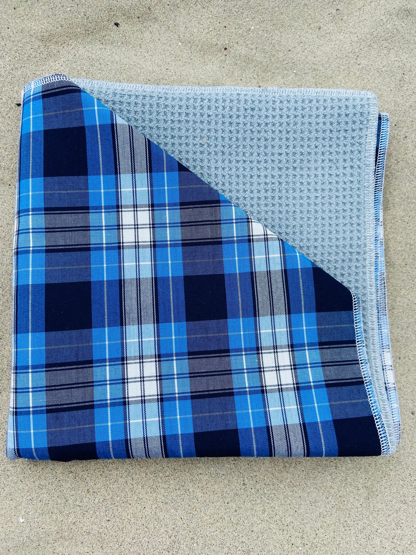Blue Tartan Plaid Golf Towel, Folded on Sand