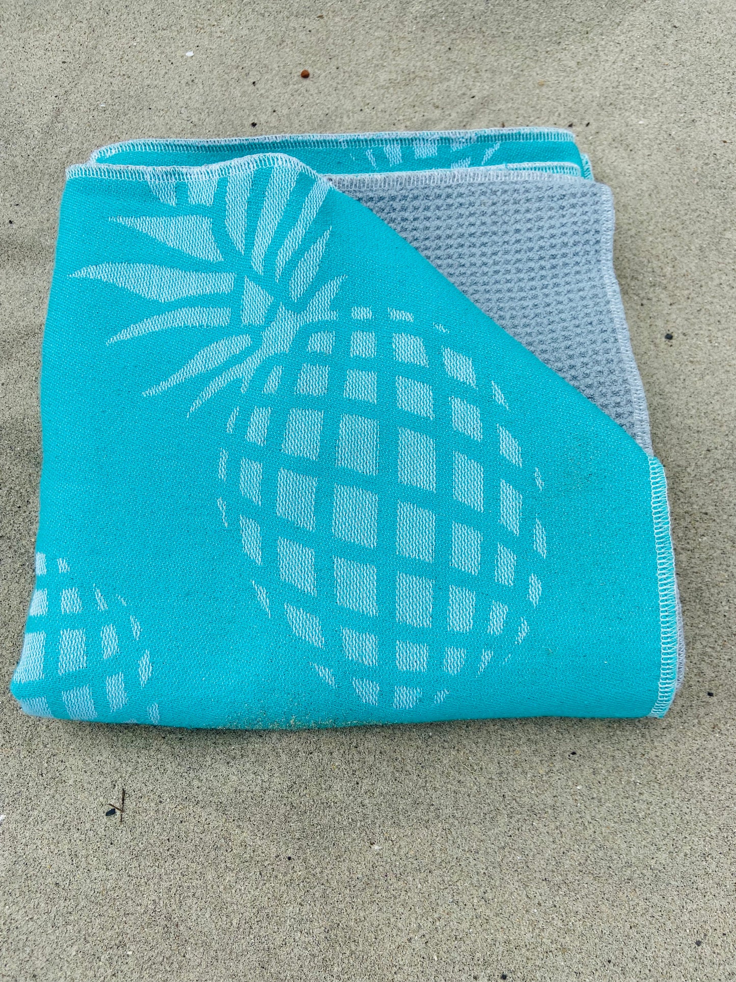 Folded Teal Pineapple Golf Towel with Gray Interior