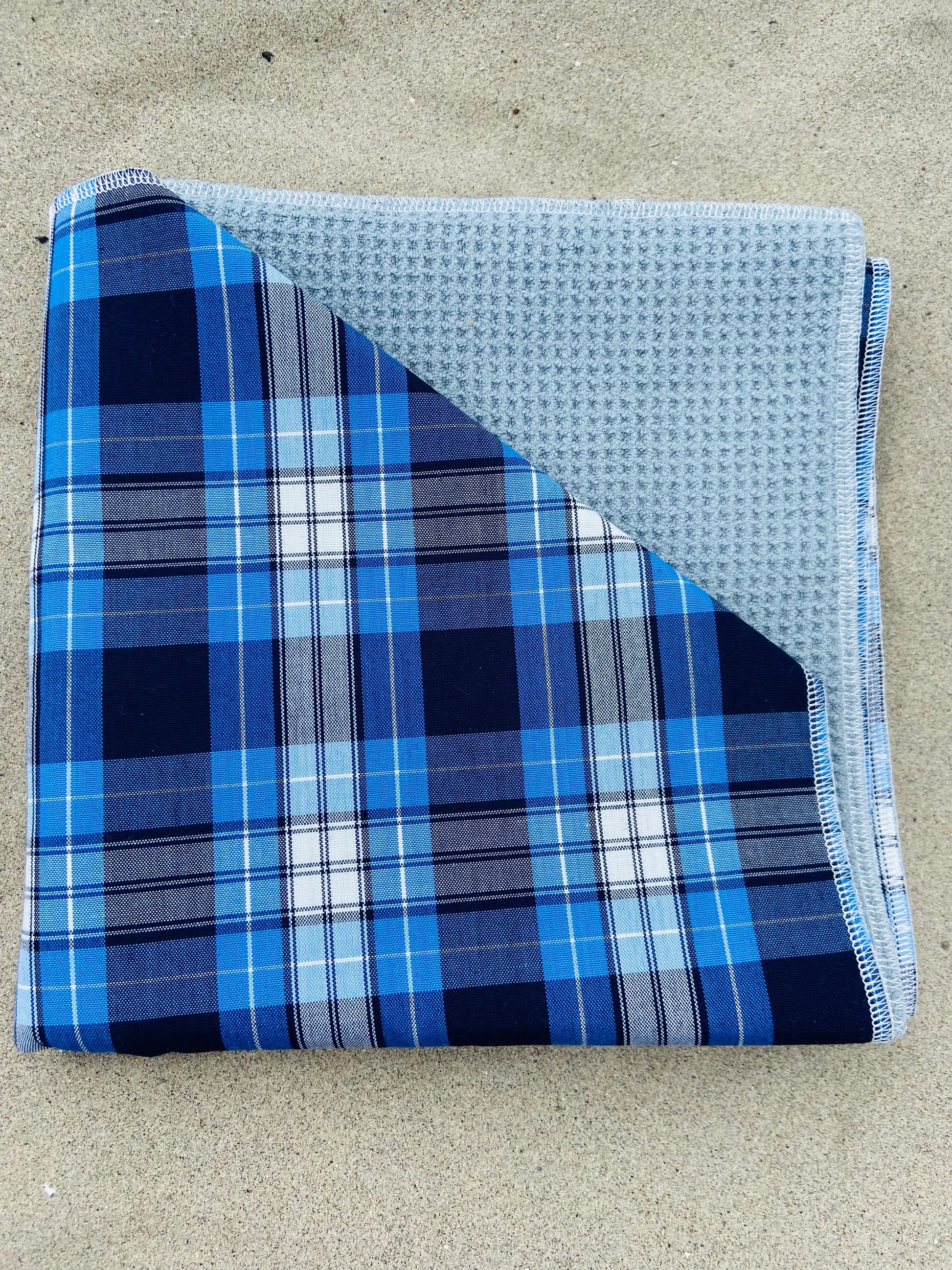 Blue Tartan Plaid Golf Towel, Folded on Sand